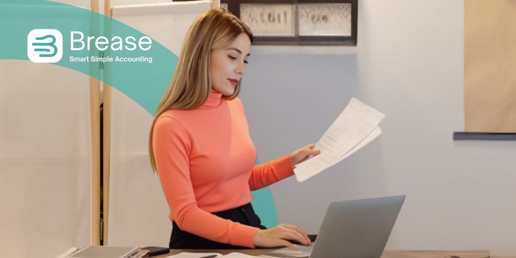 Sole trader reviewing business records on a laptop with Brease Accounting